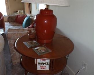 round revolving bookcase, lamp with shade, books