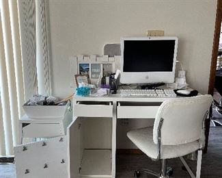 Desk, Apple monitor, keyboard, miscellaneous office supplies