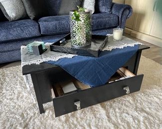 Coffee table with drawer, area rug