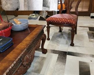 Carved coffee table, 3 side chairs.  9 x 12 skin rug and fun "poof"