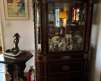 Vintage china cabinet with figurines