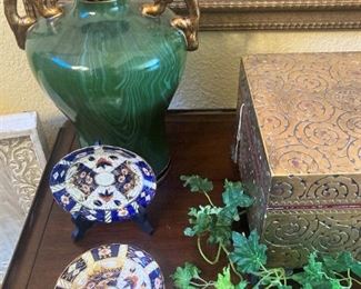 One of two matching green urns