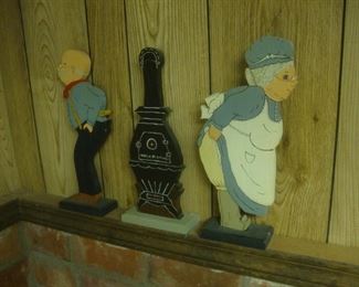 Wood figures warming by stove