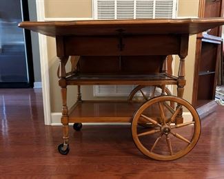 Beautiful antique drop leaf rolling serving cart with glass insert and side drawer.                                                                 
29"H x 43"W extended x 32"D
