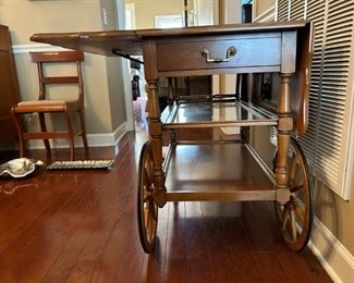 Beautiful antique drop leaf rolling serving cart with glass insert and side drawer.                                                                 
29"H x 43"W extended x 32"D