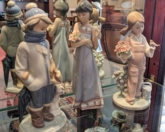 Lladro collectible figurines: Winter Child, Girl with Flowers, Spring Girl.  