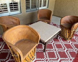 Beautiful and unique southwest patio set. The table has a solid slate top. The set has a matching smaller slate table