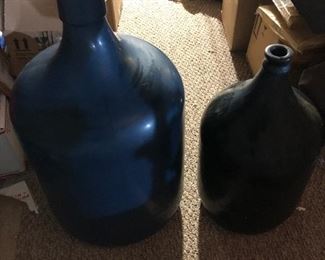 Large old glass bottles, have been painted in their life time. Larger one marked 1937