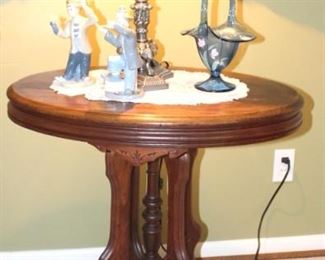 Small antique parlor table with Fenton glass basket and home decor.
