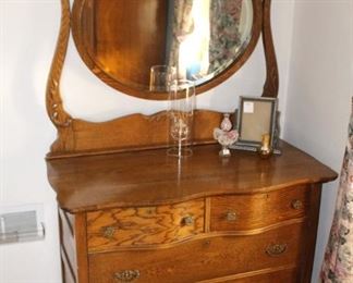 Antique serpentine oak dresser with mirror.                            48" W x 70" H x 20" D.