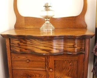 Antique oak serpentine dry sink.                                                      34" W x 50 1/2" H x 16" D.