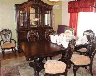 China/display cabinet, dining table with six chairs (two are arm chairs).  Table comes with two leaves and protector pads/covers.  
