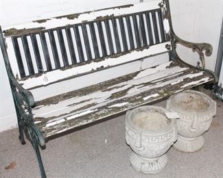 Iron base garden bench and pair of concrete planters.