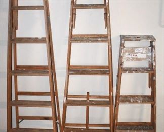 Three wood step ladders.