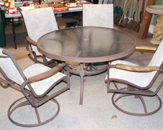 Glass top patio set with swivel chairs.