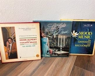 Several box set vinyl albums from the 1950s, including Herb Alpert and the Tijuana Brass