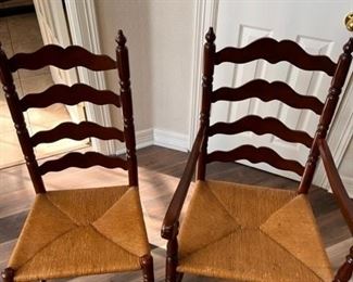 Table and six ladder-back chairs with woven wicker seats