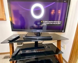 Sony LCD 40" TV, LG Blu-Ray/HD DVD player, TV Stand.
