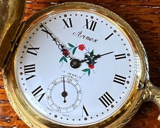Gold Plated ARNEX Pocket Watch in Display Case 17 Jewel Caliber	Case: 7.5 inches high.	
