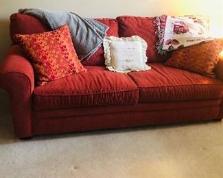 The sofa looks orange in the pic however it is red