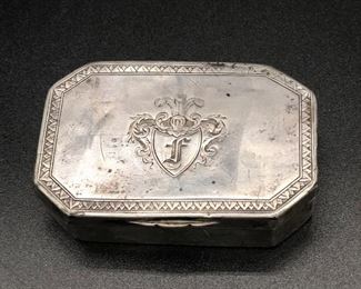 Silver octagonal snuff/keepsake box with sawtooth embossed edge and center shield with engraved F
