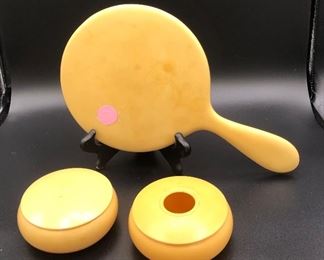 Bakelite dresser set includes mirror, hair receiver, and powder box