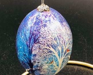 Egg ornament /red birds in a snowy tree