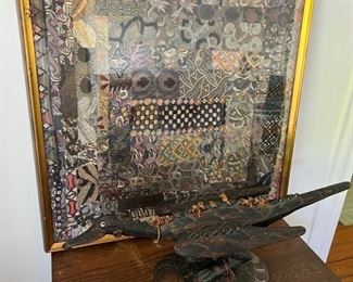 framed textile, likely from turkey. carved african bird