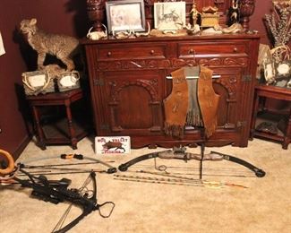 HUTCH WITH TWO LARGE DOORS, TWO SMALL DOORS, AND TWO DRAWERS, ORNATE WOOD. SET OF TWO OCTAGON SHAPED END TABLES --WOOD WITH BEVELED GLASS INLAY TOP.  TWO COMPOUND BOWS AND ONE CROSSBOW