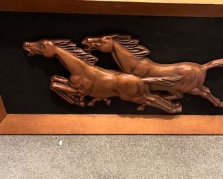Striding horses relief sculpture