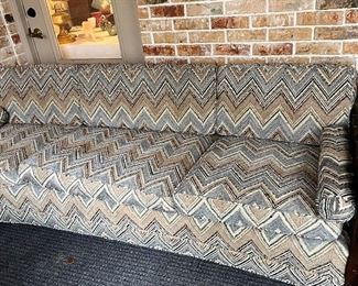 curved mid-century sofa with zig-zag upholstery
