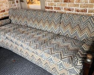 curved mid-century sofa with zig-zag upholstery
