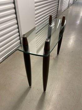 $225 USD     Mid Century Modern Glass 2 shelf Coffee Table PA107-7      Mid Century Modern glass top coffee table.  This piece originally had a second glass top that sat atop the four double tapered legs. 

DIMENSIONS: 41 x 13 x 30H

LOCATION: Local pick up NE Washington, D.C.  Contact us for shipper suggestions.

CONDITION: Used. The table is in good vintage condition. As noted the top glass shelf is missing.     https://goodbyhello.com/products/mid-century-modern-glass-2-shelf-coffee-table-pa107-7?_pos=7&_sid=7ea65b4aa&_ss=r