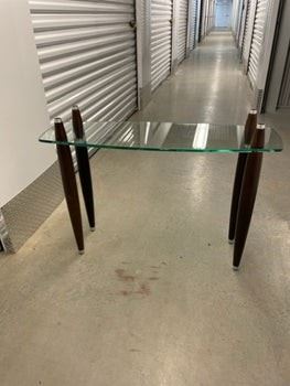 $225 USD     Mid Century Modern Glass 2 shelf Coffee Table PA107-7      Mid Century Modern glass top coffee table.  This piece originally had a second glass top that sat atop the four double tapered legs. 

DIMENSIONS: 41 x 13 x 30H

LOCATION: Local pick up NE Washington, D.C.  Contact us for shipper suggestions.

CONDITION: Used. The table is in good vintage condition. As noted the top glass shelf is missing.     https://goodbyhello.com/products/mid-century-modern-glass-2-shelf-coffee-table-pa107-7?_pos=7&_sid=7ea65b4aa&_ss=r