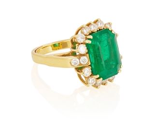 8
A Zambian Emerald And Diamond Ring
18k yellow gold; Stamped: 18k
Centering a rectangular emerald-cut emerald gauged at 14.54mm x 10.80mm x 8.96mm with an AGL report dated January 30, 2023 stating Zambian origin with minor traditional clarity enhancement surrounded by eighteen round full-cut diamonds totaling approximately 1.65cts. in weight and graded G-H color and SI1 clarity
Ring size: 7.5
11.7 grams
0.625" W x 0.75" H
Estimate: $5,000 - $7,000