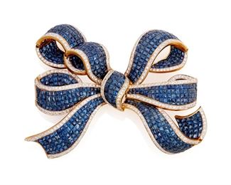 17
A Sapphire And Diamond Bow Brooch
18k yellow and white gold; Stamped: 750 / S.D.
A large invisibly-set sapphire and diamond bow brooch set with approximately six hundred fifty-five calibre-cut sapphires totaling approximately 50.00cts. in weight and bordered with three hundred fifty-five round full-cut diamonds totaling approximately 6.50cts. in weight and each graded H-I color and SI clarity
73.0 grams
3.75" W x 2.5" H
Estimate: $6,000 - $8,000