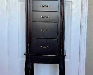 Black jewelry armoire. Top opens and has mirror and ring storage. Sides open for necklace storage. 5 d...