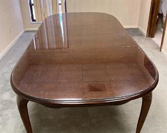 8' conference/dining table with glass top. Has (2) 12" leaves.