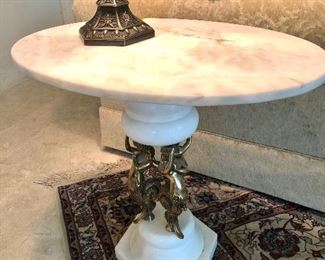 Oval marble top side table with cherub base