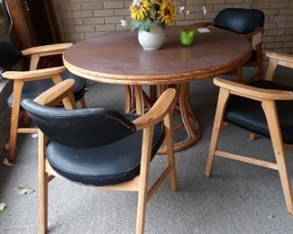 Vintage rattan table and a set of four MCM barrel chairs