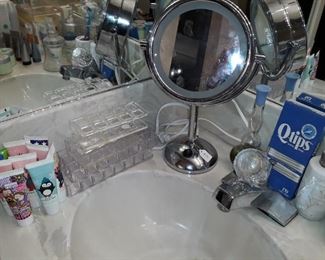 Lighted makeup mirror, vintage acrylic tissue covers, makeup storage items, and Avon creams, makeup, cologne, lotions, and more.