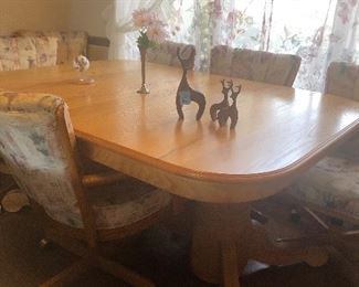 Dining tables with 6 rolling chairs.
The owner covered 4 more chairs with the same fabric so she could seat 10 people