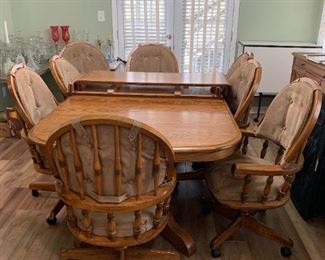 #59	Oak Rectangular Table w/2 leaves & 8 Heavy Wooden Chairs that slightly recline on Wheels w/Tan Padded seats & Back w/arms (arms on All Chairs) w/double pedistal Feet  70-103x48x29	 $375.00 
