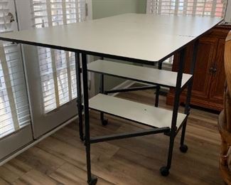 #60	Gateleg Fold-Down Cutting Table - w/2 shelves - 15.5-58.5x36Wx38T  (Height Adjustable by 10")	 $50.00 
