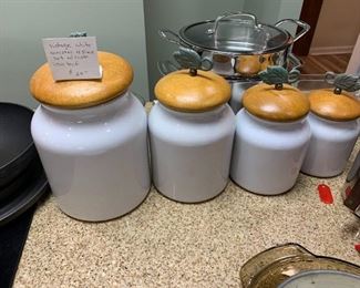 #80	Vintage White Cannister 4 pc. Set w/wood lids & Cast iron Leaf on Top	 $24.00 
