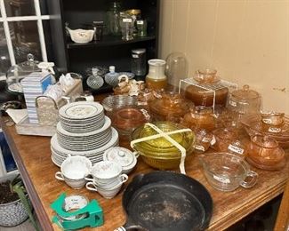 Table full or China, Griswold #8 iron Skillet and Pink depression glass and wonderful set of depression mixing bowls.  