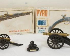 1162	LOT INCLUDING 2 VINTAGE SEALED PISTOL KITS, CAST METAL CANONS & CANON BALLS, 2 MARKED WEST POINT, LARGEST CANON APPROXIMATELY 7 IN X 3 IN HIGH
