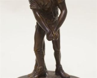 1190	BRONZE STATUE ON WOOD BASE OF MAN HOLDING BALL, APPROXIMATELY 10 IN HIGH
