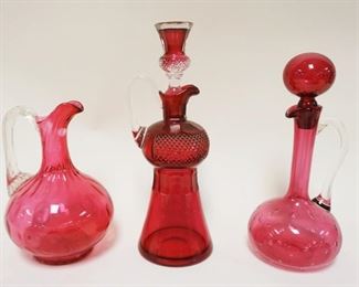 1192	GROUP OF 3 CRANBERRY DECANTERS, TALLEST APPROXIMATELY 12 IN HIGH
