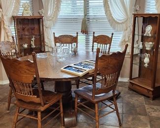 Wooden breakfast/dining table with 4 marching chairs. There are 8 other similar matching chairs.